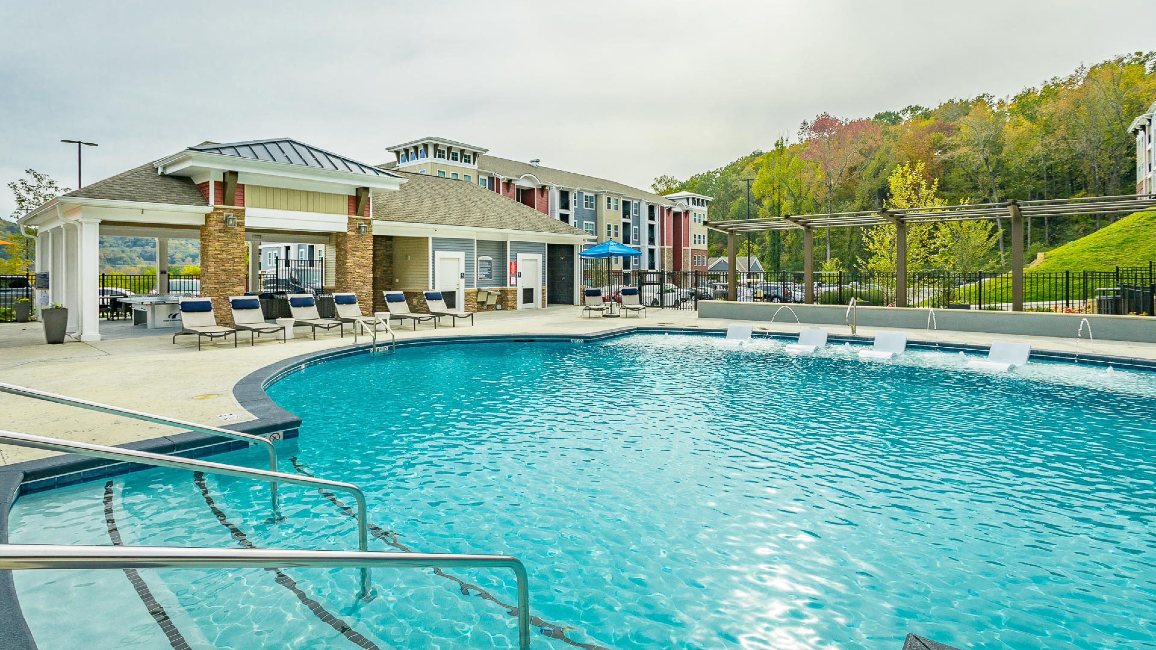 Hawthorne at the Wluxury outdoor pool with in-pool lounge chairs and surrounding seating